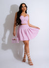 Alt text: Pink tweed skirt and matching top set with rhinestone embellishments