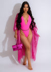 Close-up of pink rhinestone embellished swimsuit with halter neckline and high-cut legs 