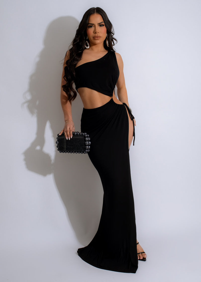 In The Resort Ruched Maxi Dress Black: Front view of elegant black dress with ruched detailing and flowing silhouette, perfect for resort wear and special occasions 