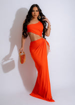 A full-length, orange ruched maxi dress, perfect for resort wear