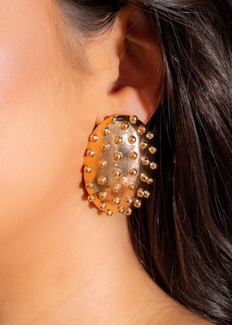 Shiny gold earrings with a bold and edgy design for bad girls