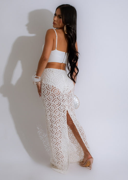  Gorgeous off-white crochet dress with a bohemian vibe, featuring a flattering halter neckline and a breezy, floor-length skirt