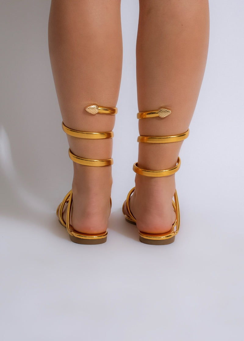 Fashionable summer glow sandal with a golden metallic finish and flat sole for all-day comfort
###