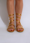 ###
Stylish gold flat sandal with shiny metallic straps and comfortable fit