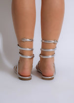 Fashionable flat sandal in silver color perfect for a summer glow outfit