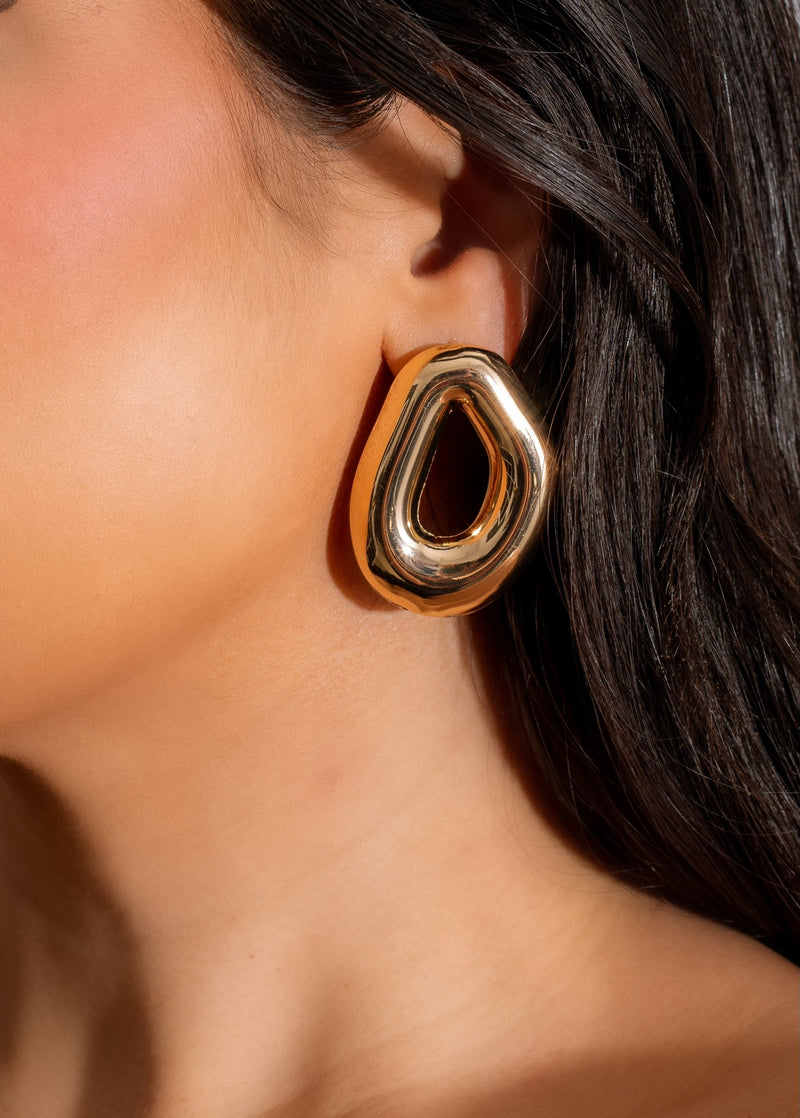 Shiny gold earring with a unique design, perfect for proving your style