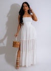 My Soul Lace Maxi Dress White on a model walking on the beach on a sunny day, the elegant lace detail adds a touch of romance and femininity to the outfit 