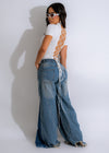 Front view of light wash distressed denim jean with raw hem