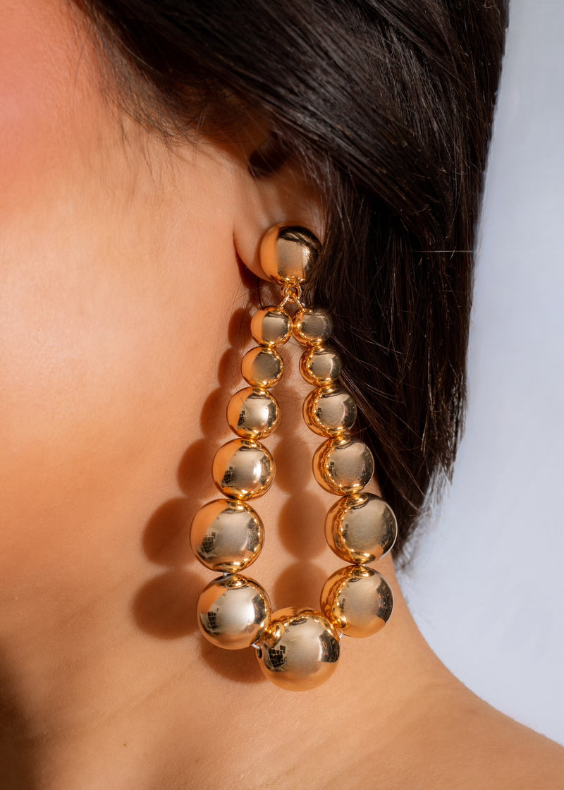 Shiny gold drop earrings in a dainty design, perfect for any occasion
