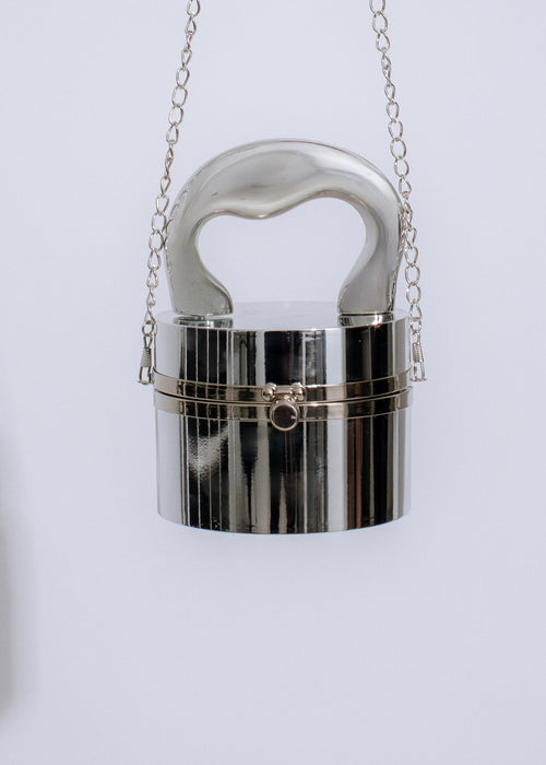 Shiny silver New Addiction Clutch with sleek design and compact size