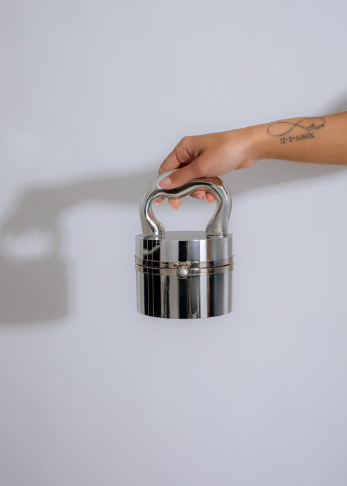 Shimmering silver New Addiction clutch with elegant design and spacious interior