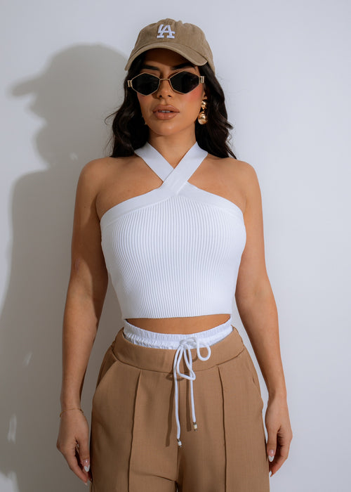 A close-up image of a white ribbed crop top, the Miss Perfect Ribbed Crop Top, featuring a form-fitting silhouette and a flattering square neckline
