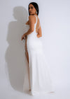 Close up of a flowing white maxi dress with lace detailing