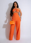 Sunny Vibes Jumpsuit Orange - A stylish and vibrant orange jumpsuit with a flattering fit and adjustable straps, perfect for summer outings and beach days