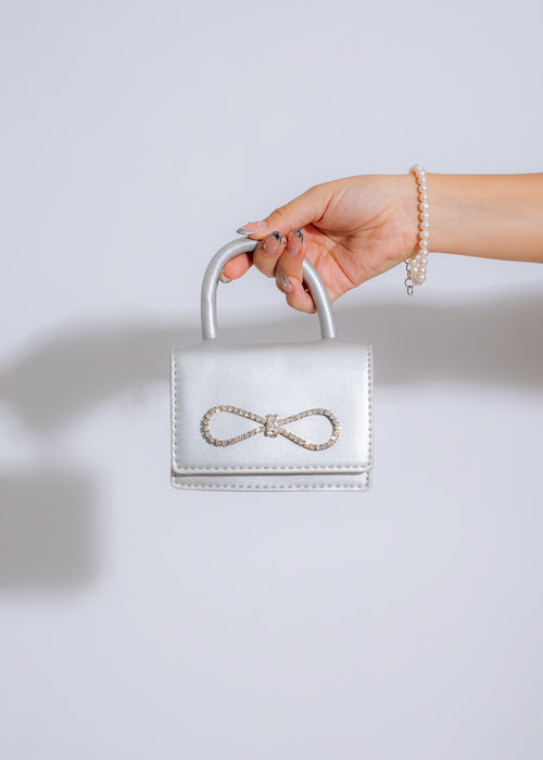 Cannes Festival Bow Handbag Silver, a sleek and stylish accessory for any formal event or night out, featuring a shimmering silver finish and elegant bow detail
