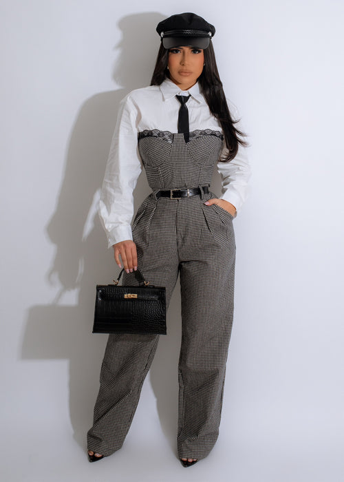 Black two-piece pant set with a flowy, pleated top and matching high-waisted trousers