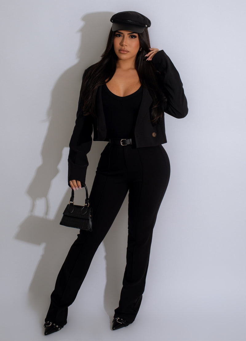 High-waisted black faux leather pants with lace-up detail and zipper closure 