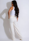 A high-waisted, wide-leg white pant with a tie belt, perfect for summer