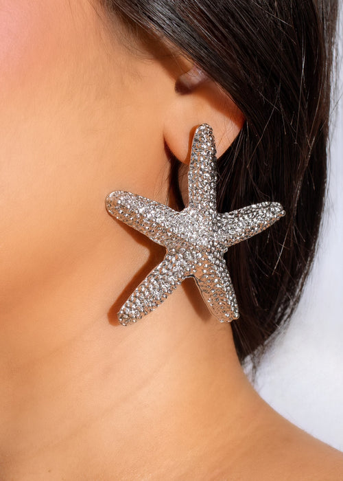Beautiful and delicate silver earrings in the shape of tiny starfish