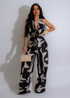 Black jumpsuit with plunging neckline and flared legs, perfect for a night out or special occasion