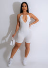 Front view of the white ribbed romper with V-neck and adjustable straps 