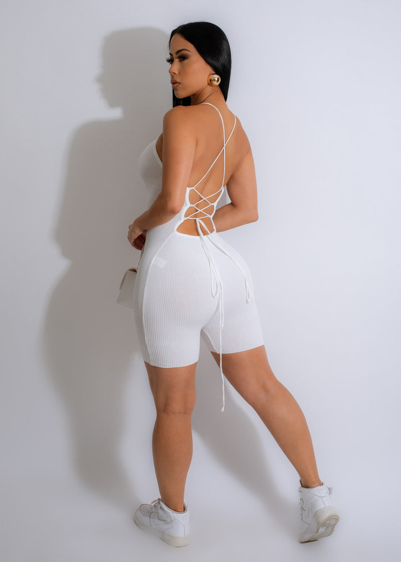  Model wearing the white ribbed romper with sneakers for a casual look