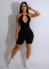 Close-up of the black ribbed romper with a flattering neckline and adjustable straps