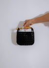 Fancy and flashy black handbag with gold accents and chain strap