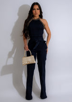 Dark denim jumpsuit with chain detail, perfect for a chic and stylish look