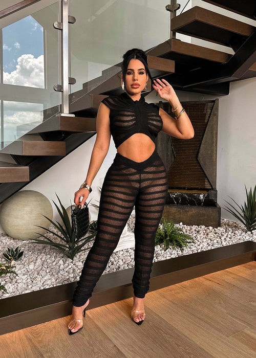 Beautiful woman wearing the Temptation Knitted Legging Set Black outfit in a cozy setting with a warm and inviting atmosphere