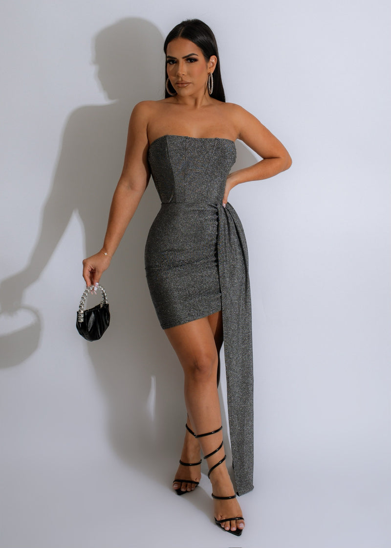Shimmery silver mini dress with a dramatic flair on display