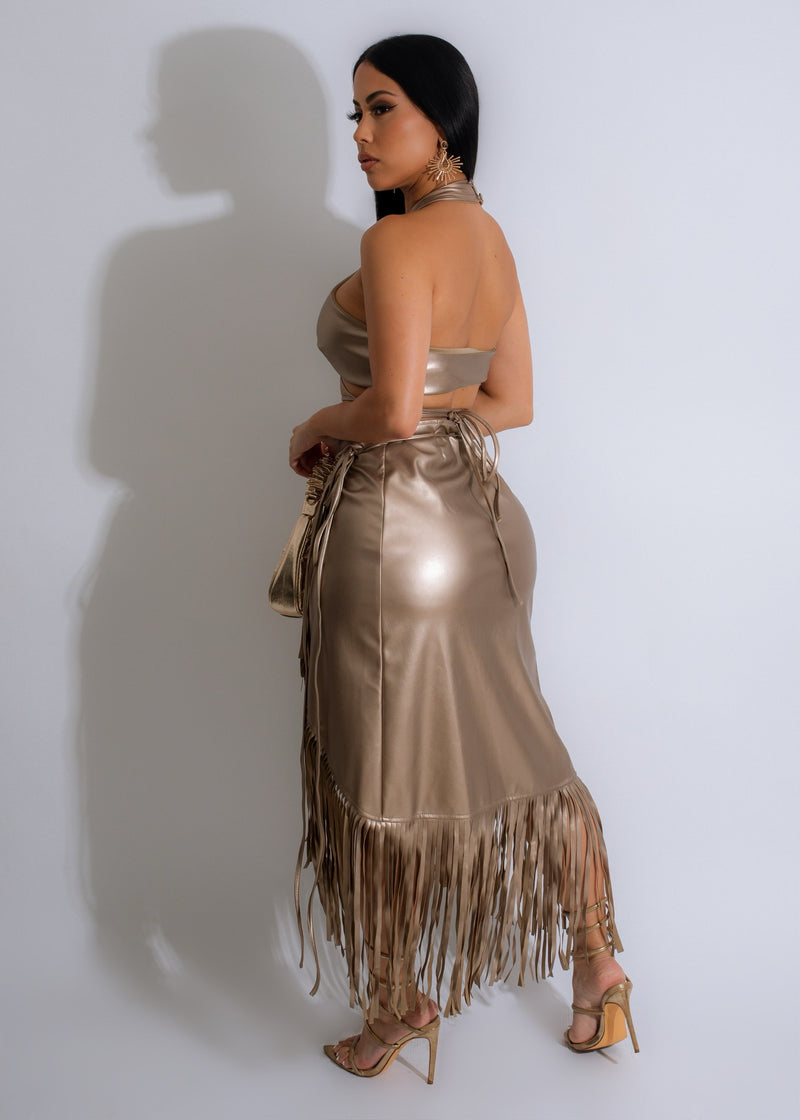 Gold faux leather skirt set with impactful fringe detailing, perfect for making a statement
