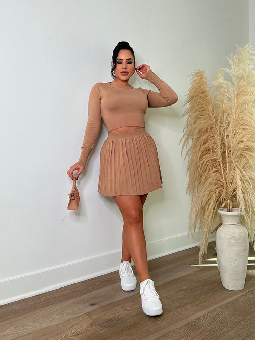 Stylish nude pleated skirt set with matching top and belt
