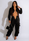  Side view of black cargo jogger pants with pockets and elastic cuffs