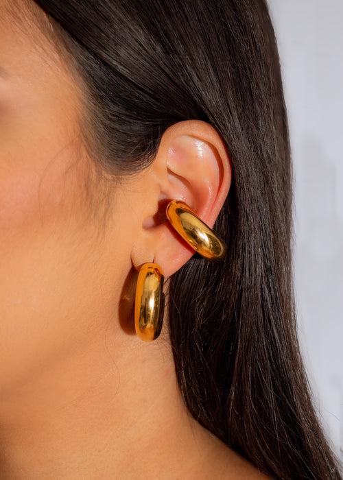 Shiny and elegant gold hoop earrings with a world map design