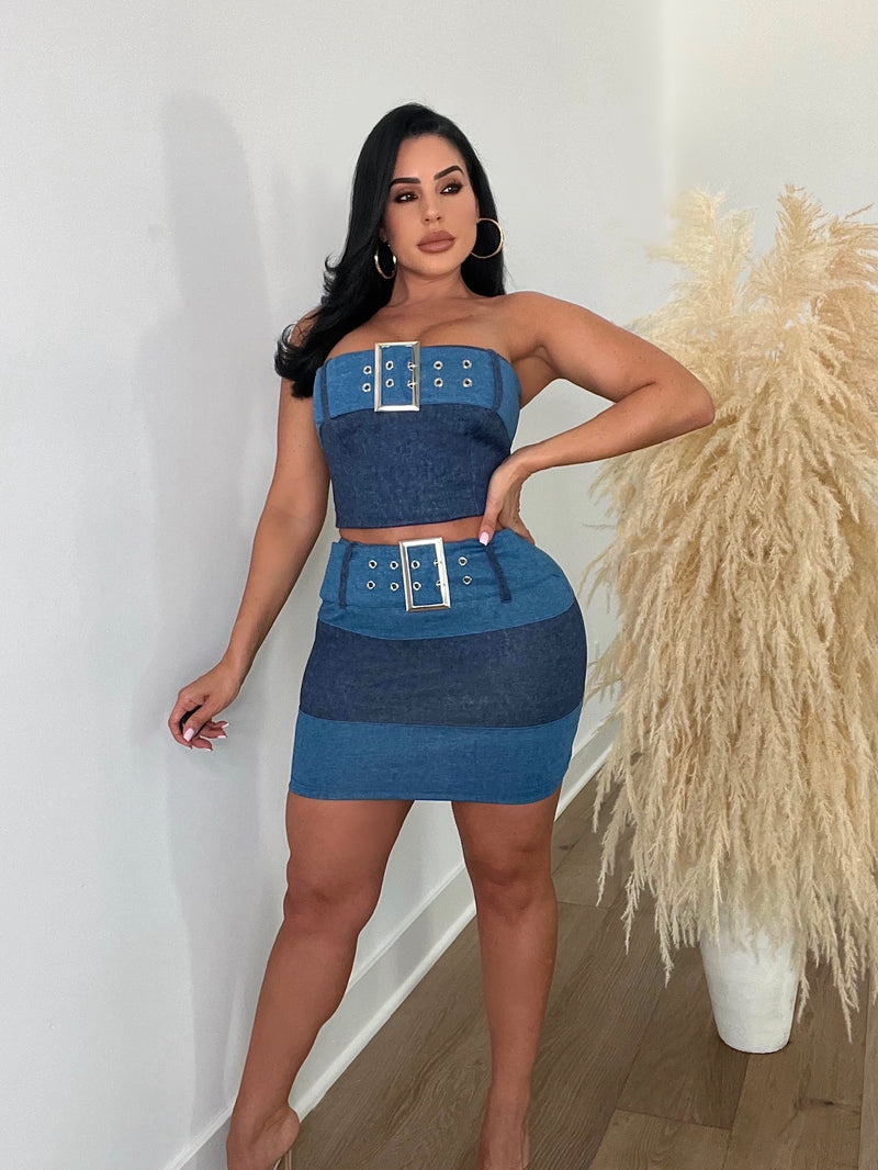  Front view of woman in denim skirt set with high-waisted fit and belt loops