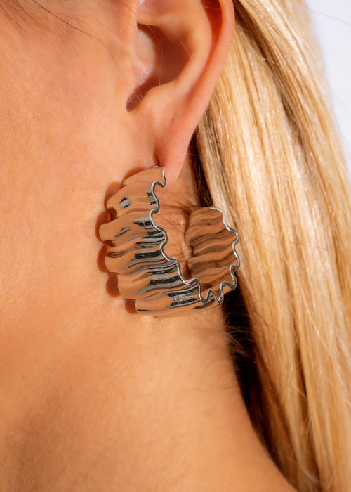 Handcrafted silver earrings with intricate design inspired by island hopping adventures