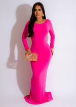 Alt text: A beautiful young woman wearing a long pink ruched maxi dress, exuding joy and confidence