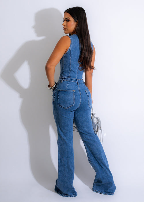 Blue denim jumpsuit with extreme flare, halter neck, and belt detail