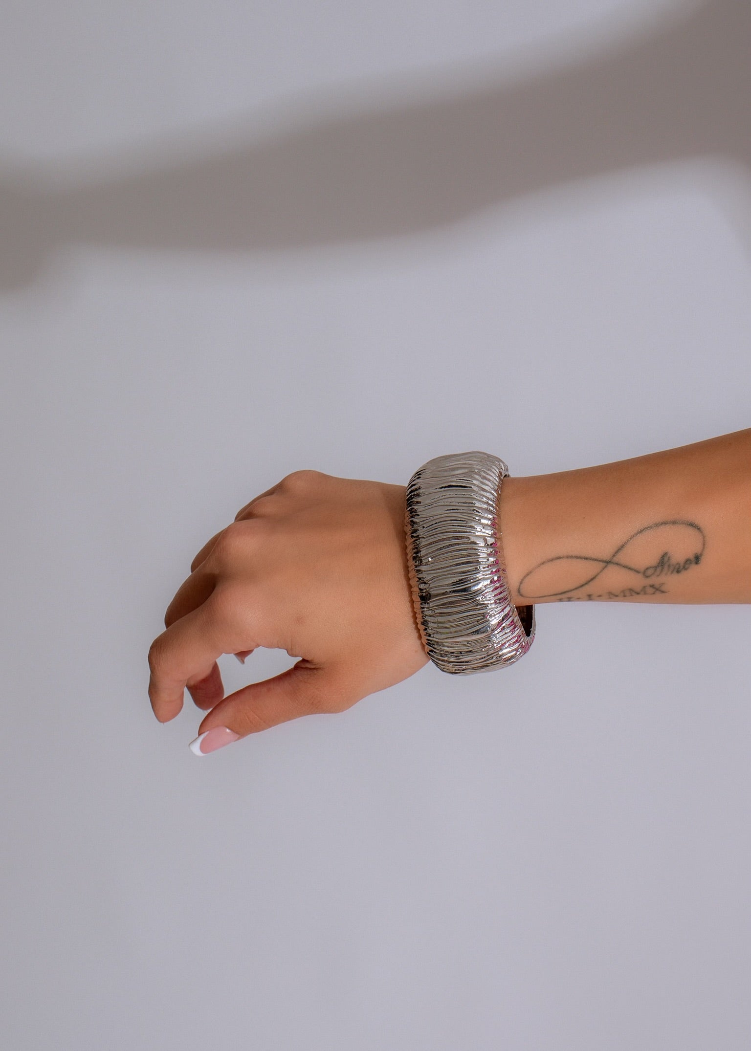 Shiny silver bracelet with the words 'Create Love' engraved, perfect for adding a touch of elegance to any outfit