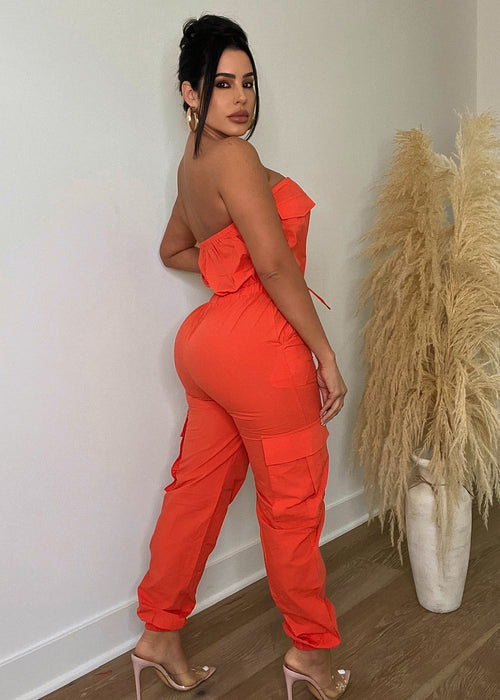 Elegant one-piece jumpsuit in vibrant orange color, featuring a flattering cinched waist and wide-leg silhouette Versatile and on-trend, perfect for any occasion from brunch to evening cocktails