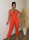 Stunning orange jumpsuit with flared legs and deep V neckline, perfect for summer events or casual wear Made from lightweight, breathable fabric for all-day comfort and style