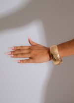Shiny gold unbreakable bond bracelet set with intricate design details