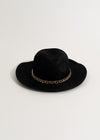 Alt text: Stylish black 'Make No Promises' hat with adjustable strap and embroidered text