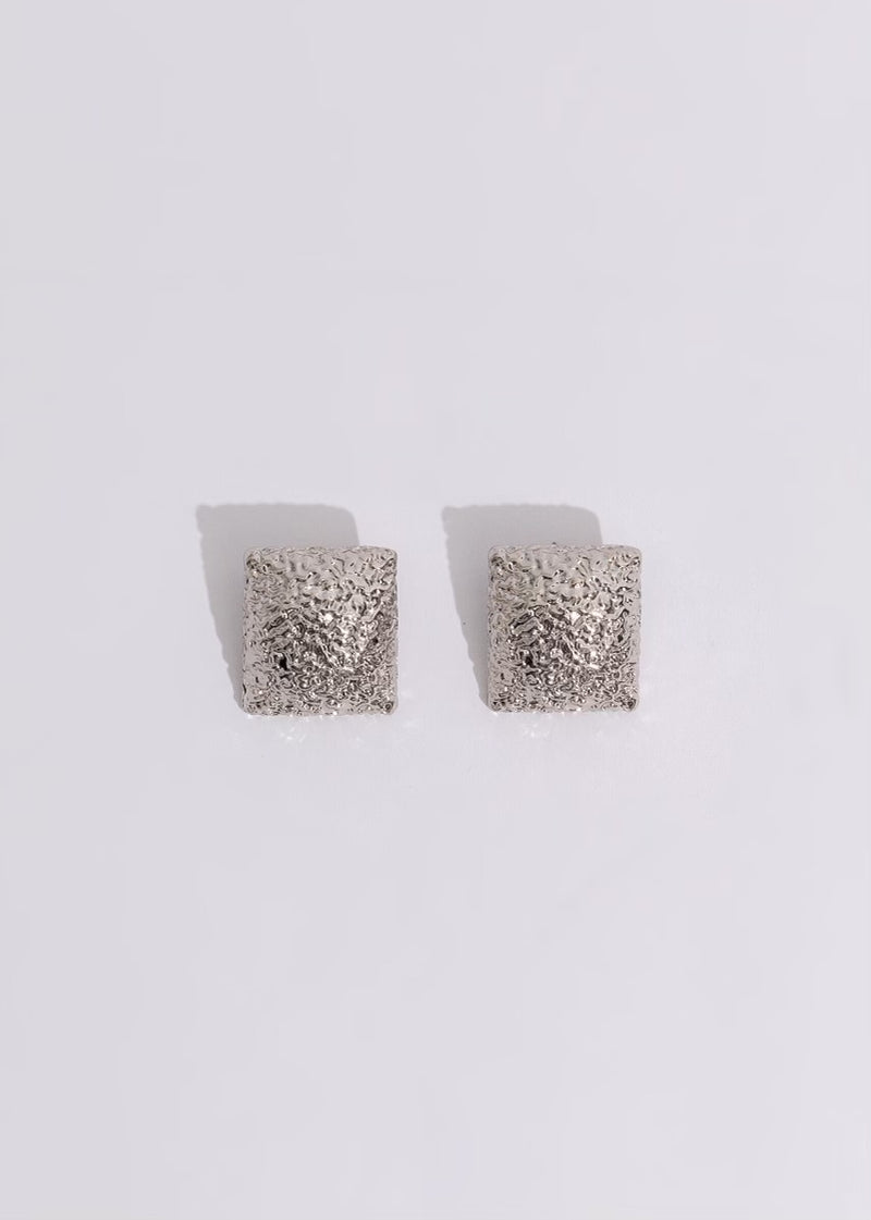 Dazzling silver earrings with intricate city skyline design, perfect for evening events