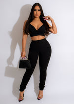 High-waisted black leggings with mesh panels and crisscross detailing 
