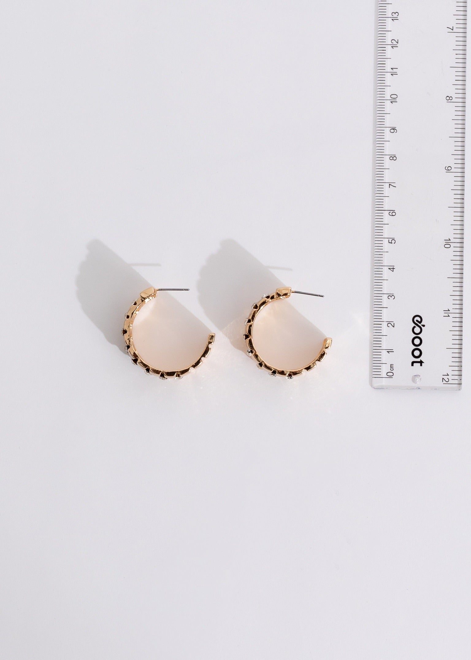 Shimmering gold hoop earrings with intricate geometric design and elegant details