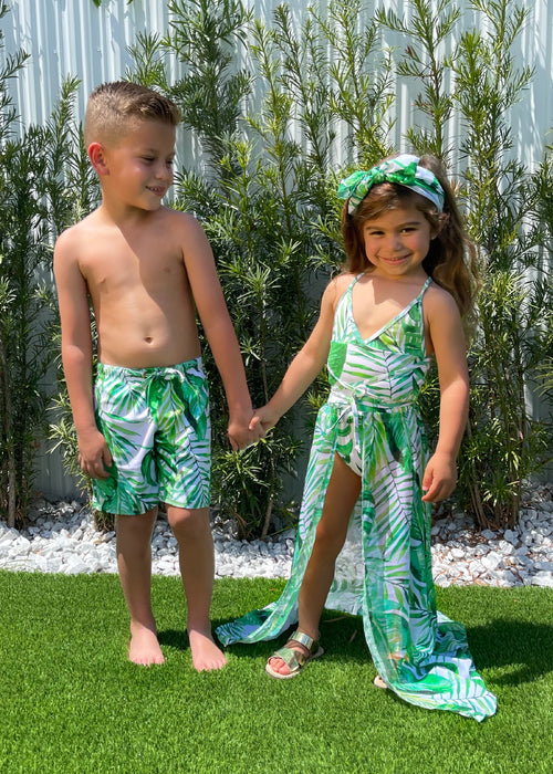 Two-piece girls swimsuit set in bright floral print with ruffle details and matching sun hat, perfect for fun in the sun and poolside play 